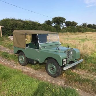 1949 early land rover in field