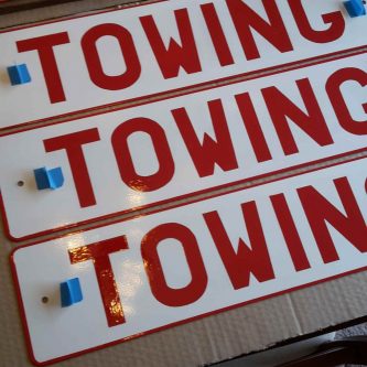 Set of four red towing signs