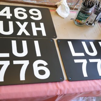 Signwritten number plates ready for posting